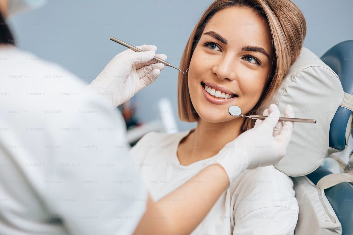 A relaxed patient smiling in the dental chair during a gentle exam